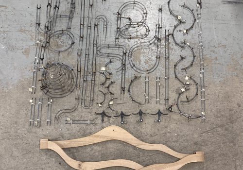 pieces of sculpture laying on the floor soon to be assembled