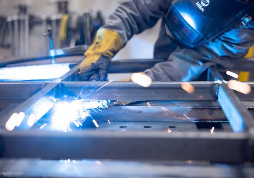 person welding parts together for the door